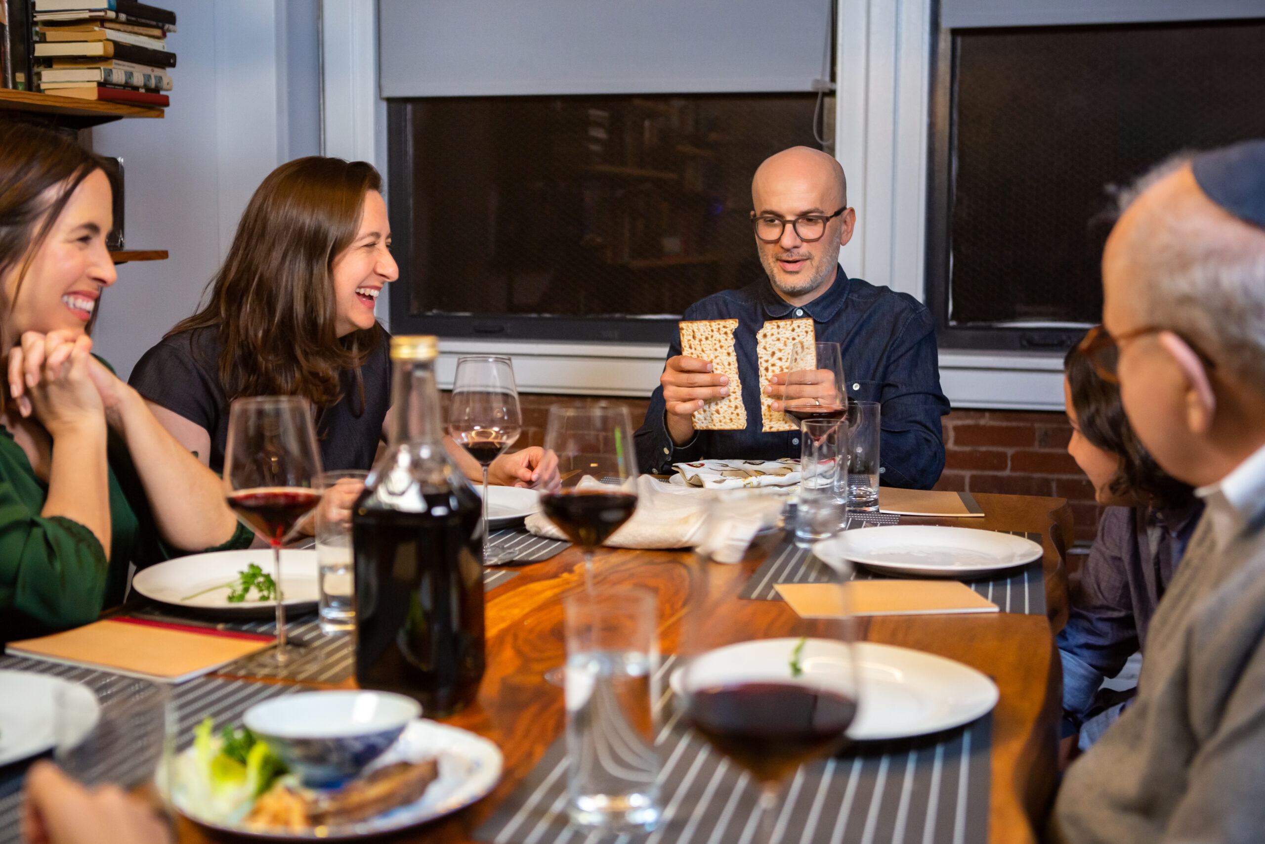 A modern Jewish American family celebrates Passover together.  The Seder leader breaks the middle matzo (Yachatz).