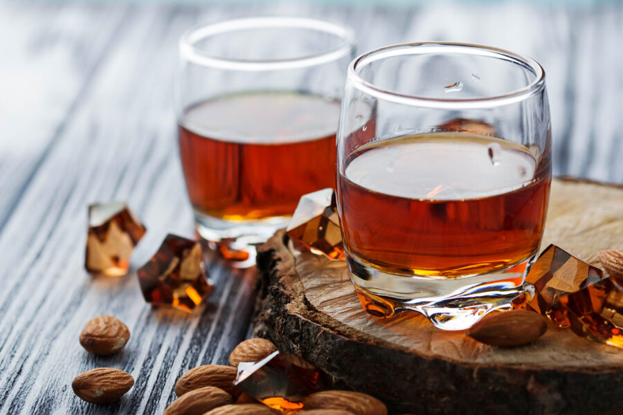 Almond liquor amaretto and almonds. Selective focus