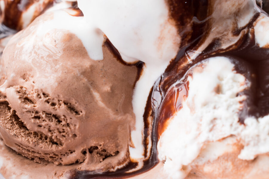 Background of ice cream with chocolate sauce falling