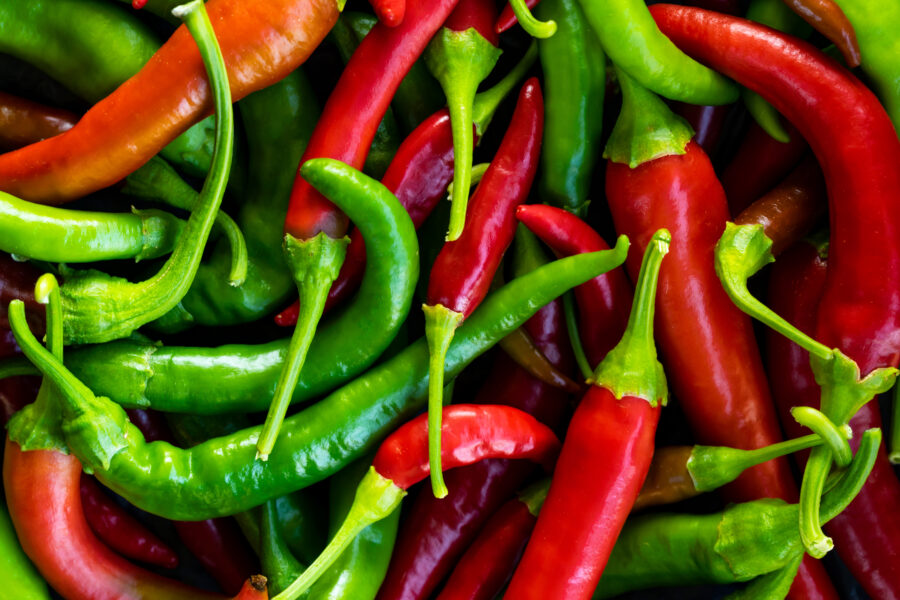 Close up photo of green and red chilli peppers