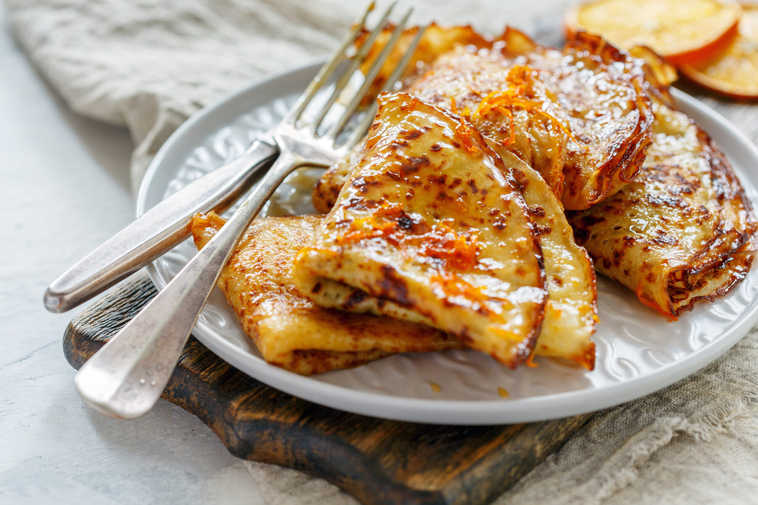 Crepe Suzette with orange sauce for a delicious breakfast, selective focus.