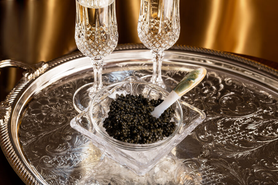 crystal glasses with champagne and black caviar