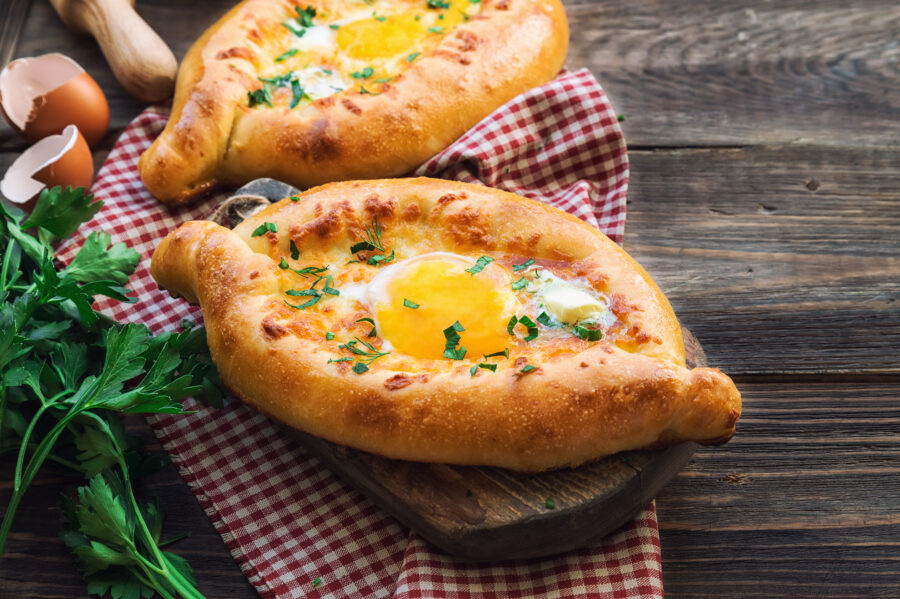 Dough boats filled with sulguni cheese and egg. Traditional Georgian cuisine.