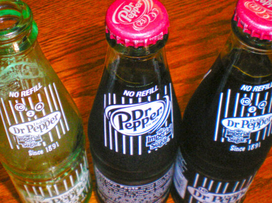 three glass bottles of different Dr. Pepper flavors