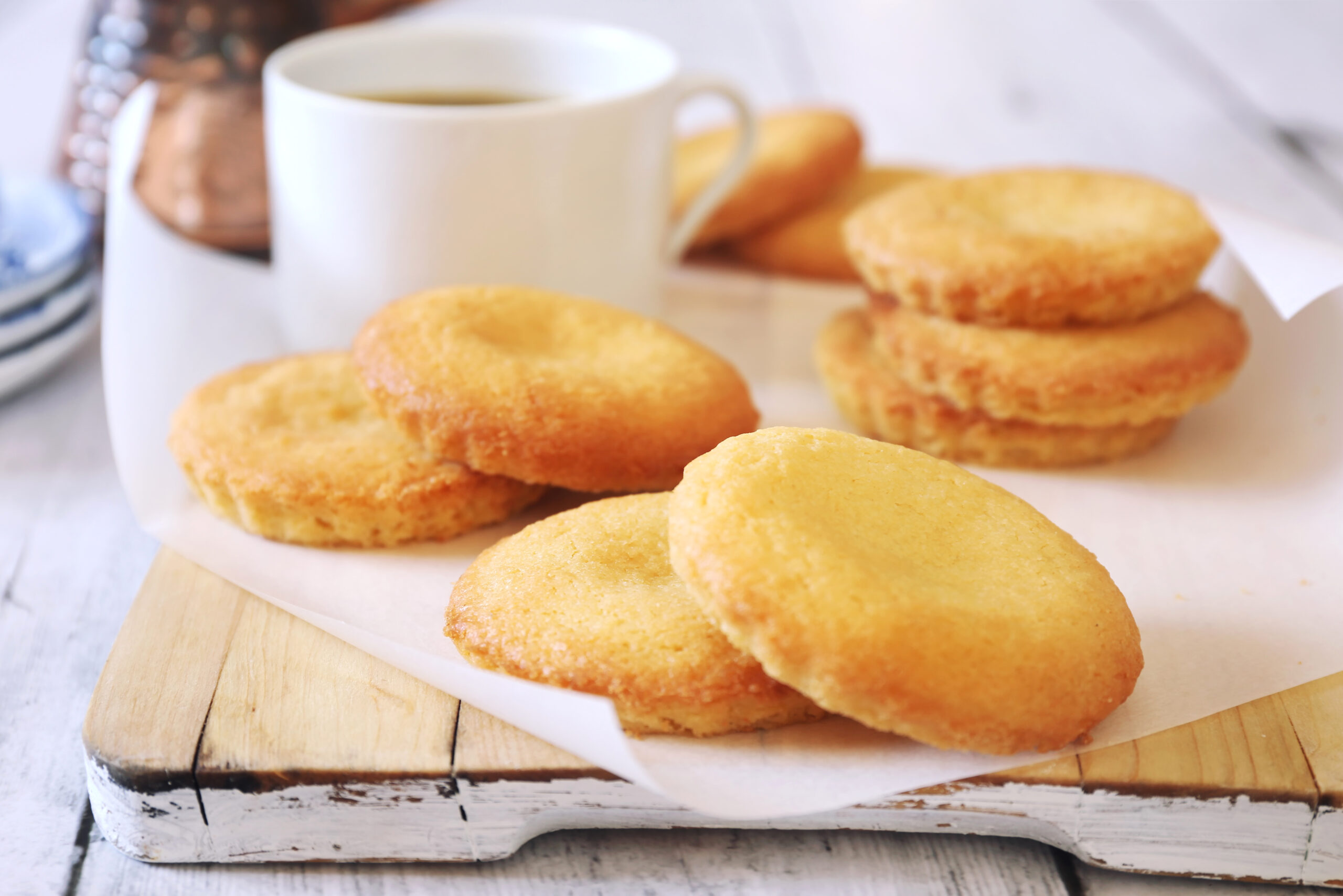 Homemade palets bretons. Salty shortbread Breton cookies, cup of coffee and cezve on light background. Focus selective