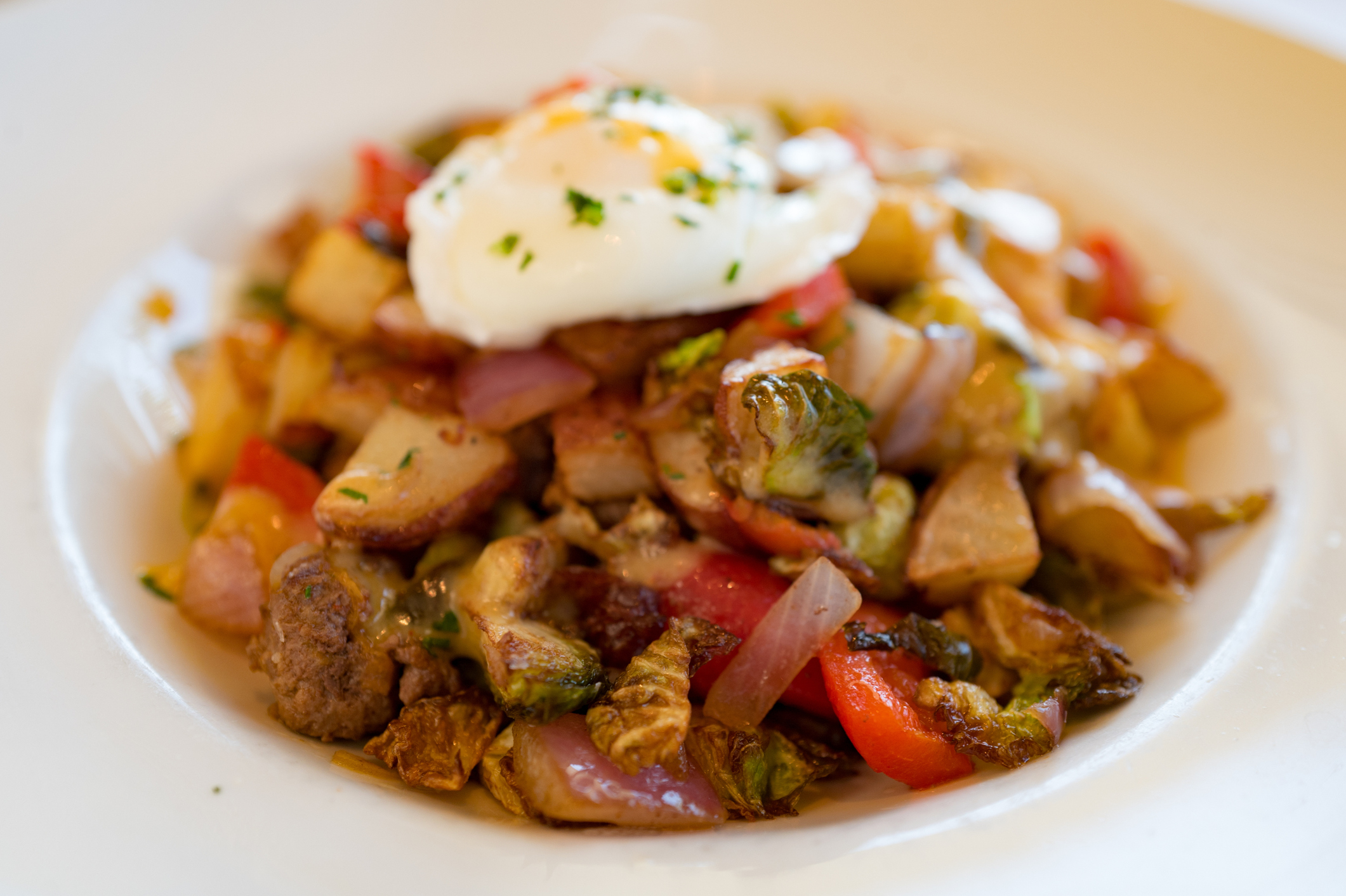 Close-up of a breakfast hash plate with steak, brussels sprouts, vegetables and a poached egg, October 20, 2018. (Photo by Smith Collection/Gado/Getty Images)