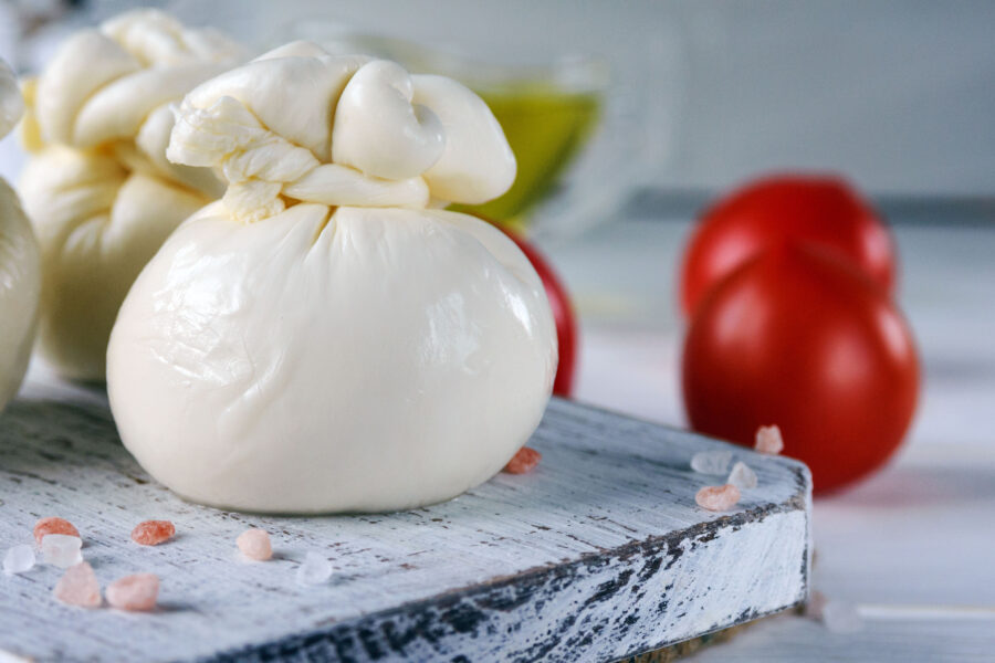 Burrata, Italian fresh cheese made from cream and milk of buffalo or cow. Close-up.