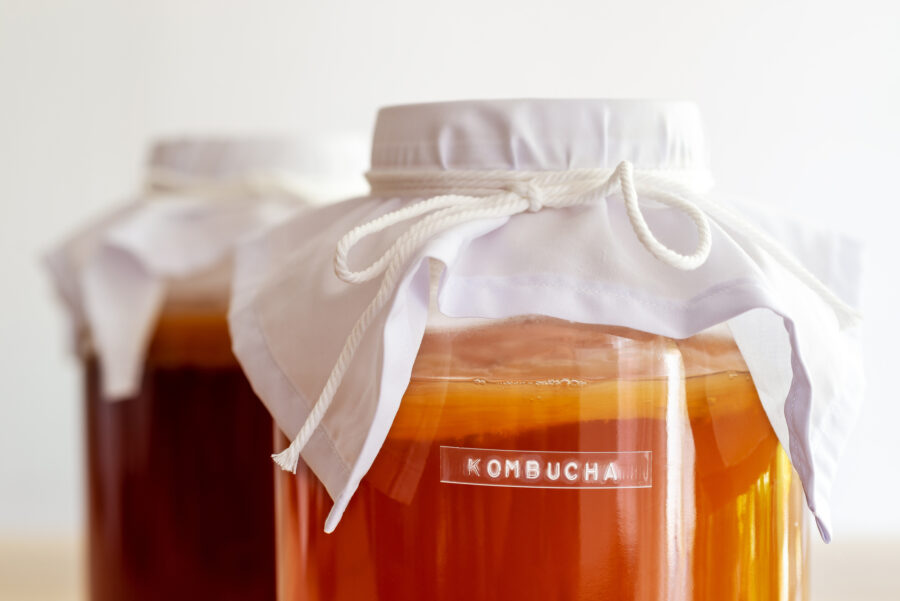 Labeled kombucha in glass jar, covered with cheese cloth