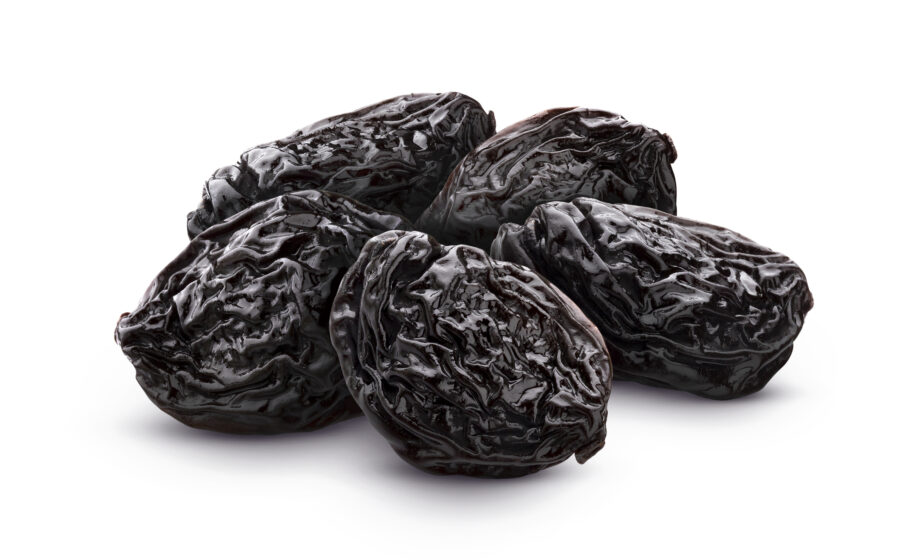 Prunes isolated on white background, heap of dried plums