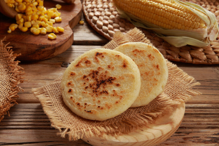 Shallow low oil fried Arepa on a rustic wood background