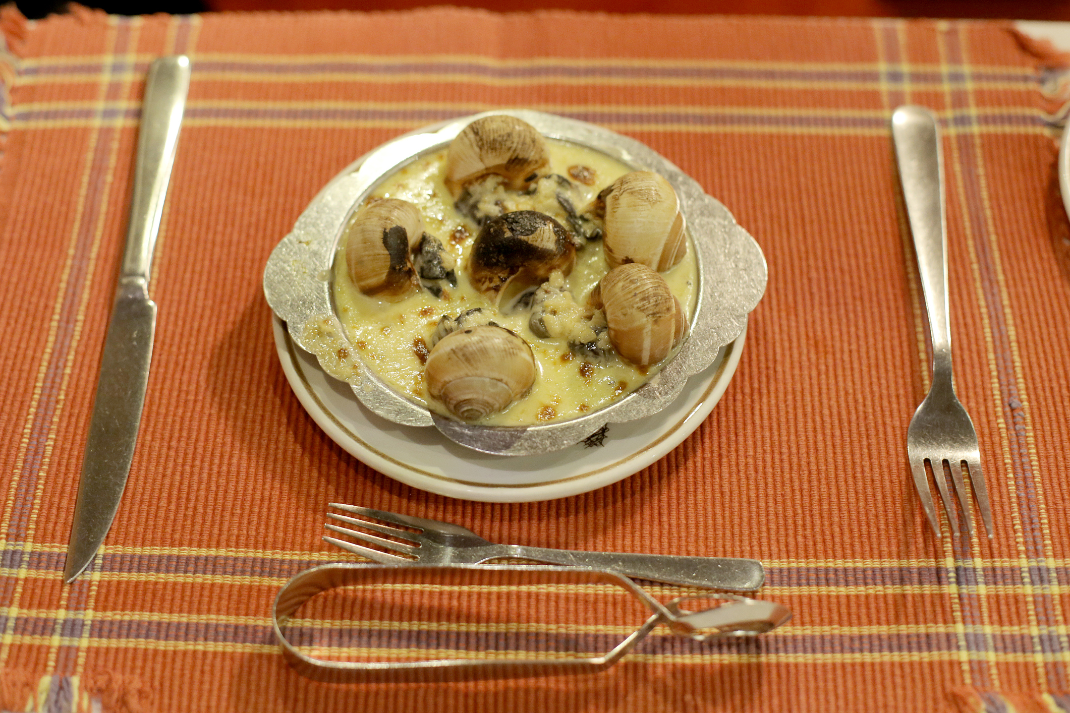 Half dozens of escargots serves as an appetizer in western restaurant.