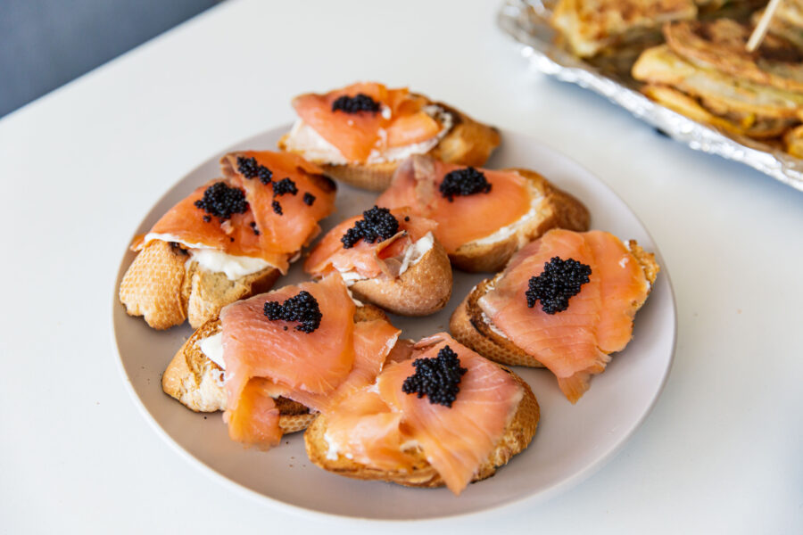 Smoked Salmon Canapés Topped with Caviar on a Porcelain Plate