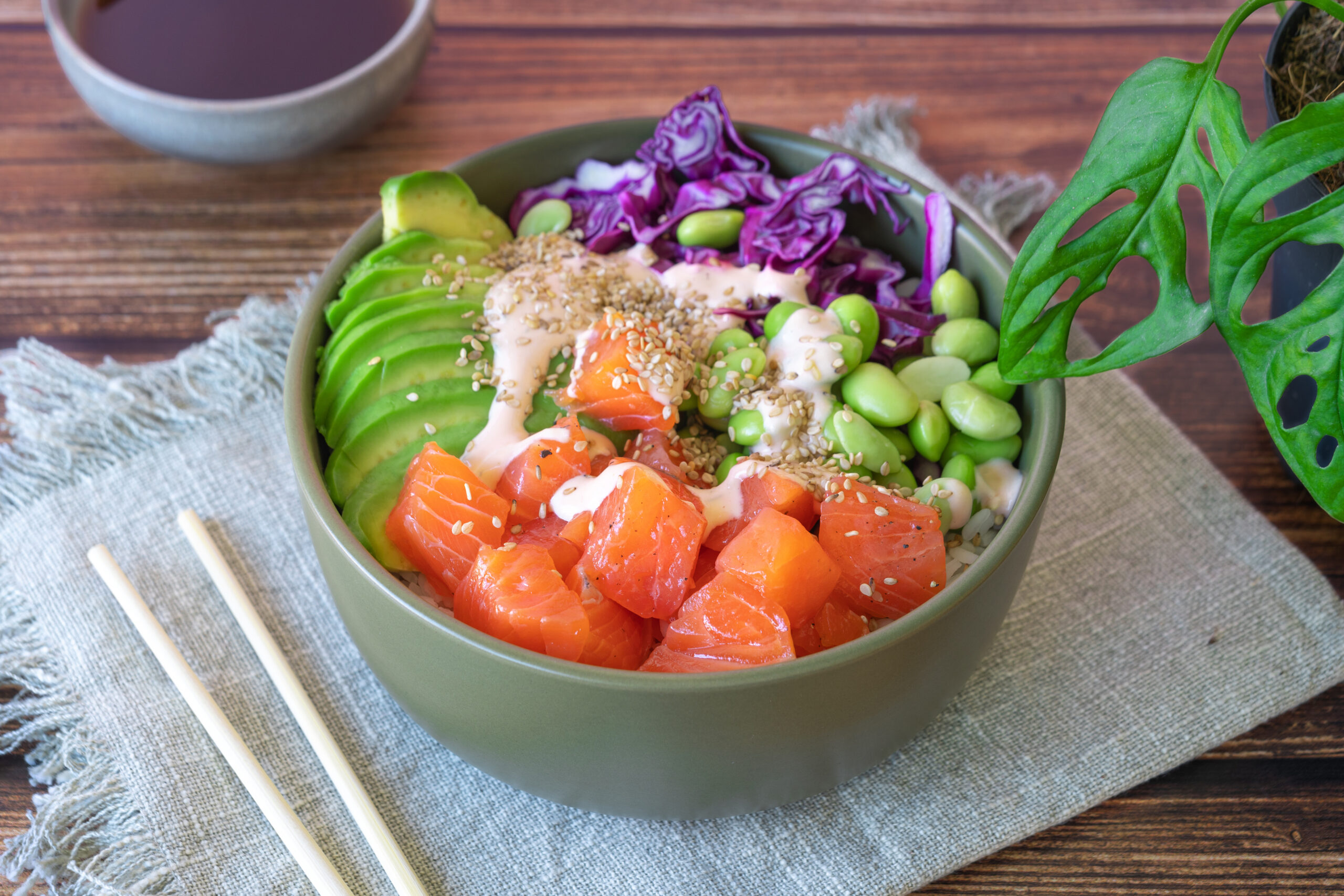 poke bowl with salmon on wooden table