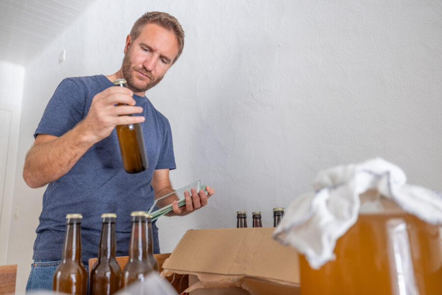 master brewer examining new batch of kombucha bottles