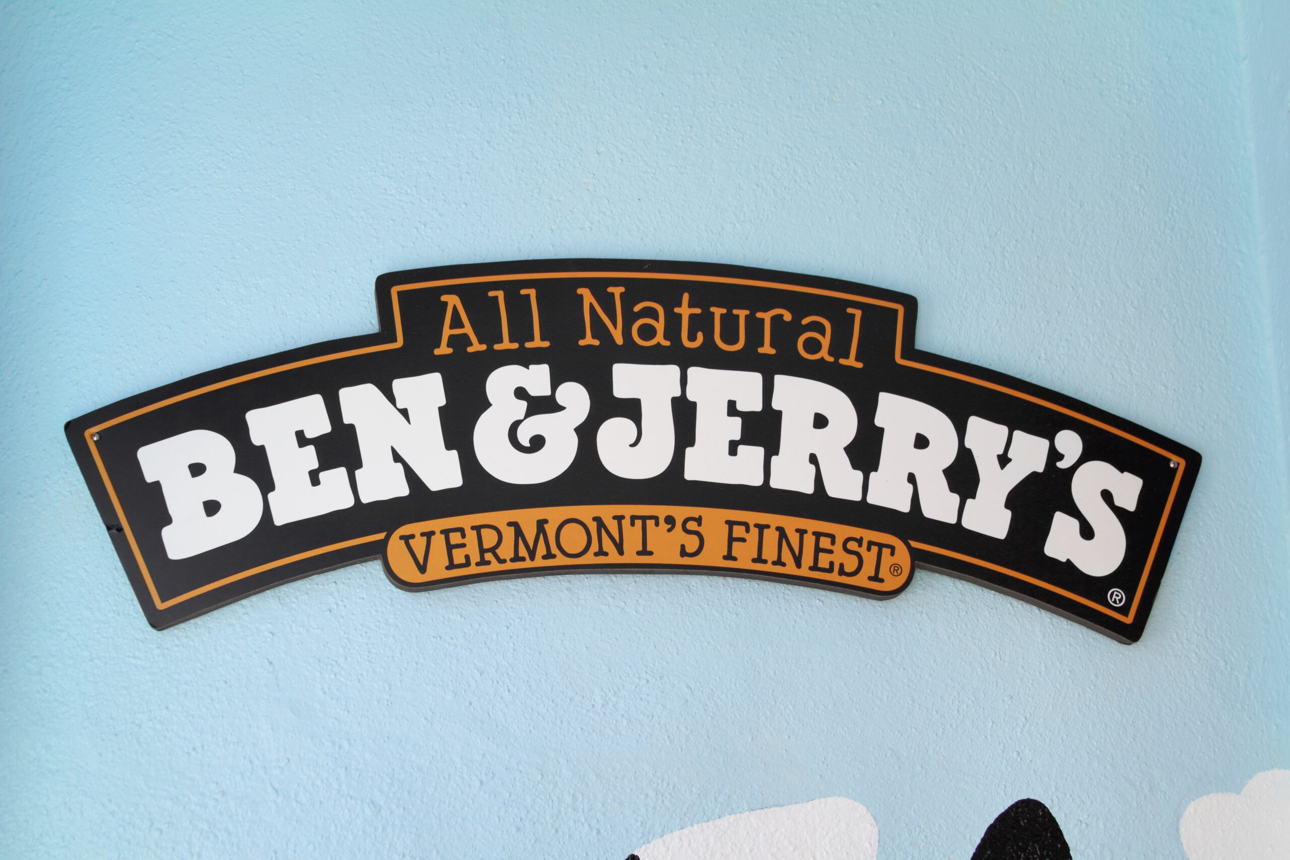 A Ben and Jerry's Ice Cream shop sign on a shop wall