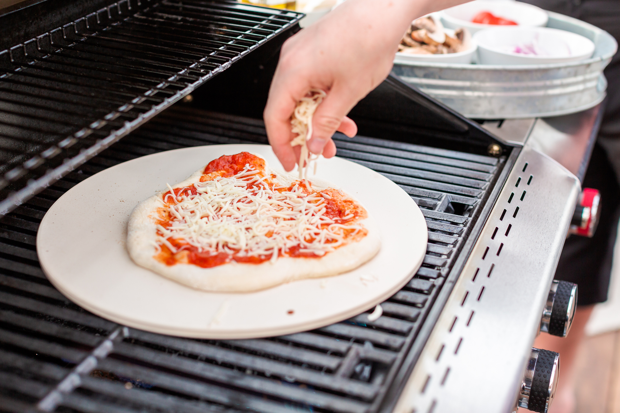 Cooking pizza on outdoor gas grill.