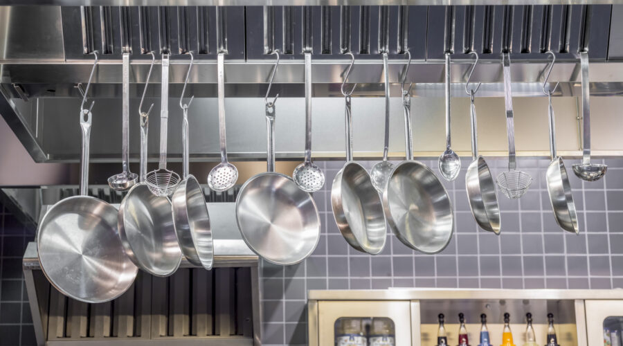 Industrial Kitchen , pots and tools on shelves.