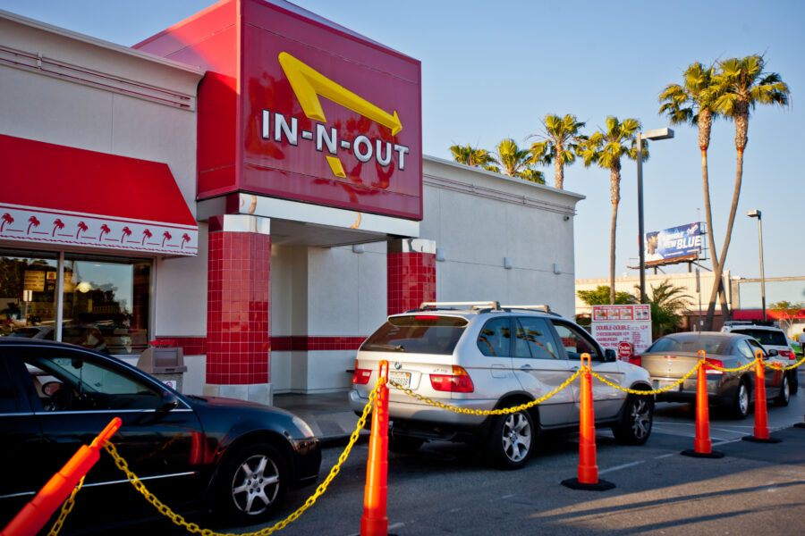 Los Angeles, USA - May 13, 2013: In-n-out Burger, fast food restaurant at Los Angeles Airport. Many cars are waiting in line to be served in drive-through part of restaurant.