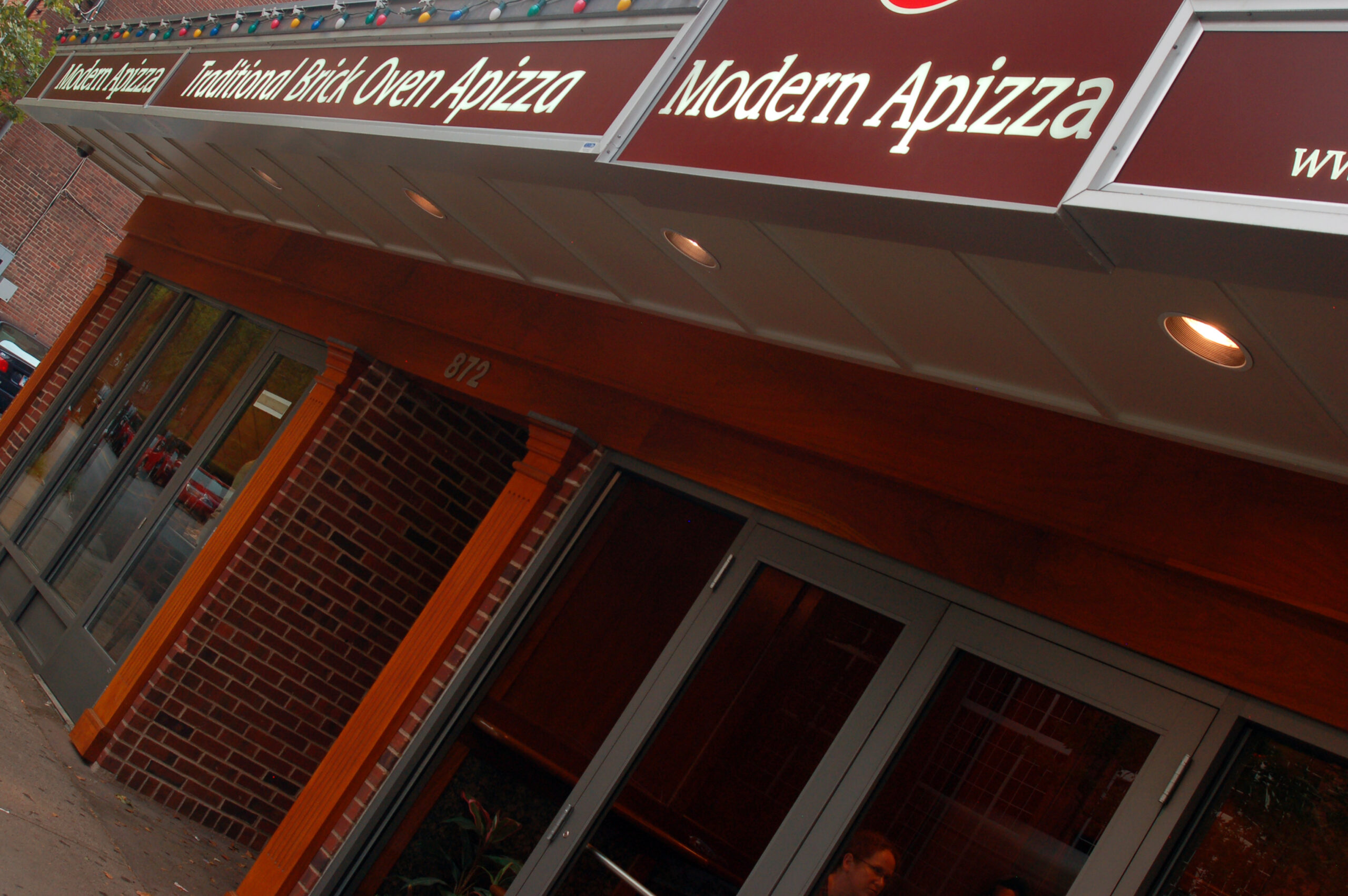 a sign hangs over the entrance to Modern Apizza, one of the original pizzerias and Italian restaurants in New Haven, Connecticut