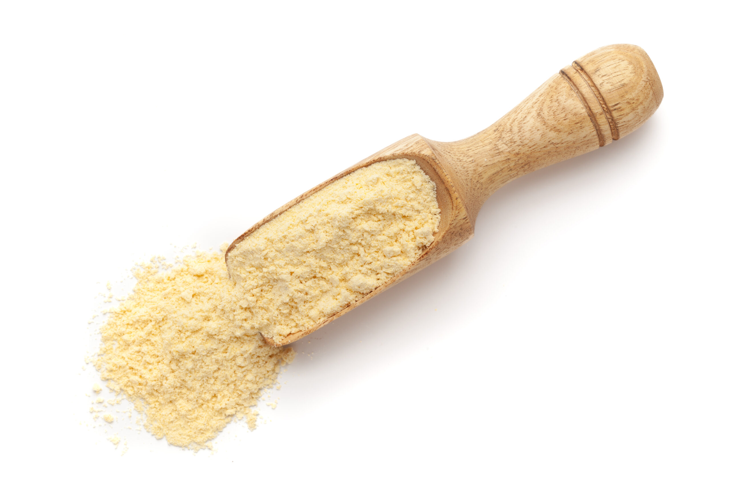 Organic Corn Flour (Zea mays) or Makka Flour in a wooden scoop, isolated on a white background. Top view