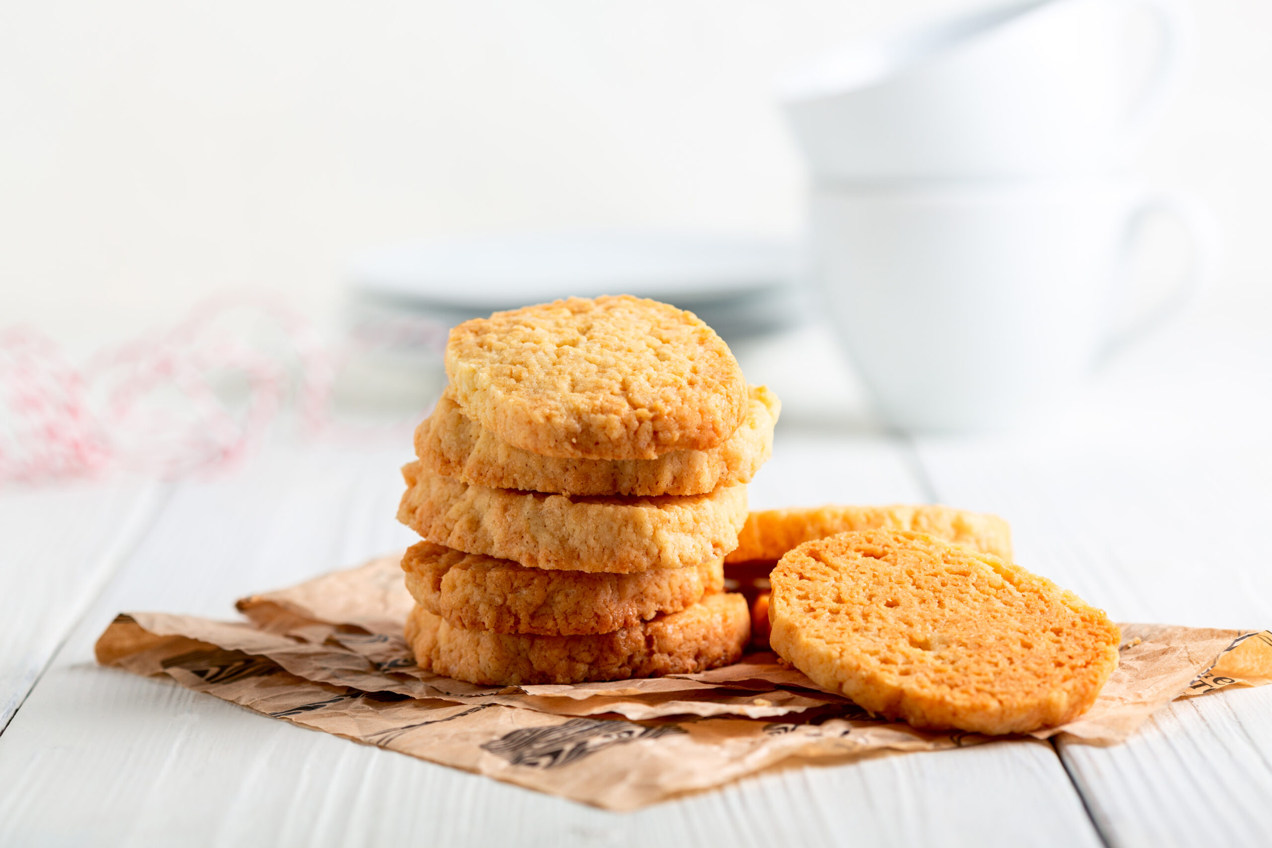 Stack of shortbread cookies on a paper backing, selective focus. Copy space. Concept of sweet homemade baking.