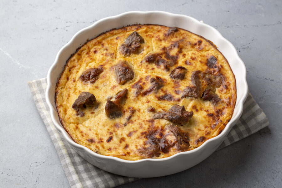 Tave kosi is a national Albanian dish of baked lamb and rice with yoghurt close-up in a pan on the table. horizontal top view from above.