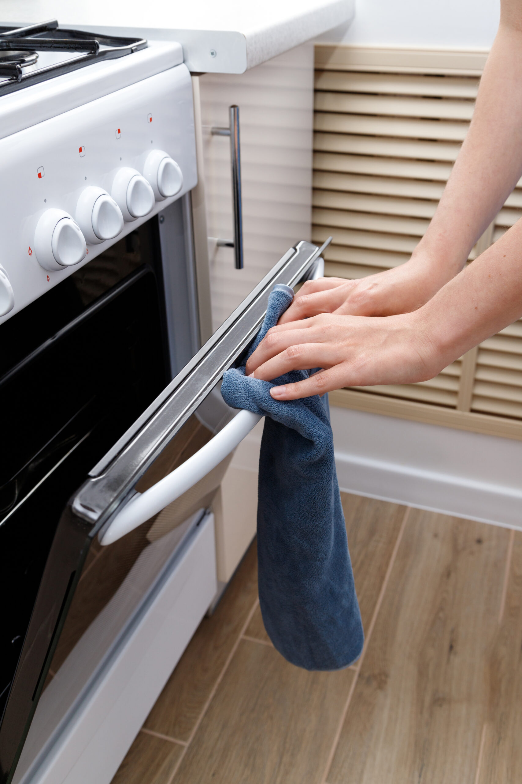 woman opens the oven in the kitchen close-up