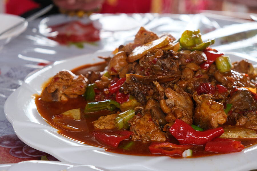 Xinjiang big plate chicken. Spicy chicken meat with colorful peppers. 