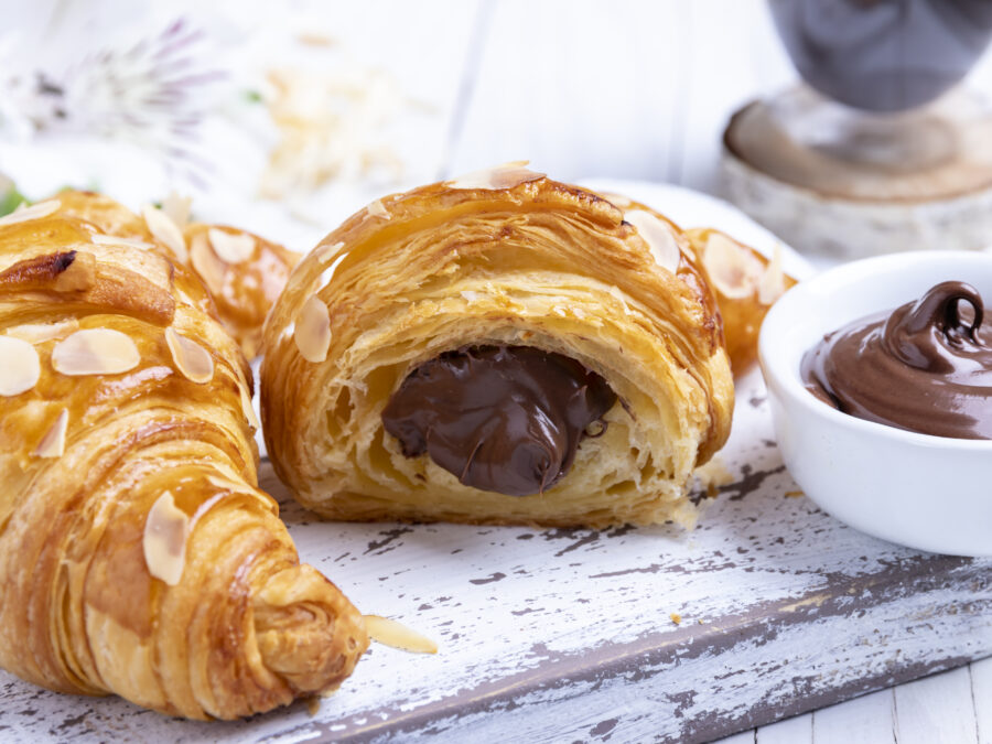 croissant, sliced almonds, with chocolate filling cut, close up