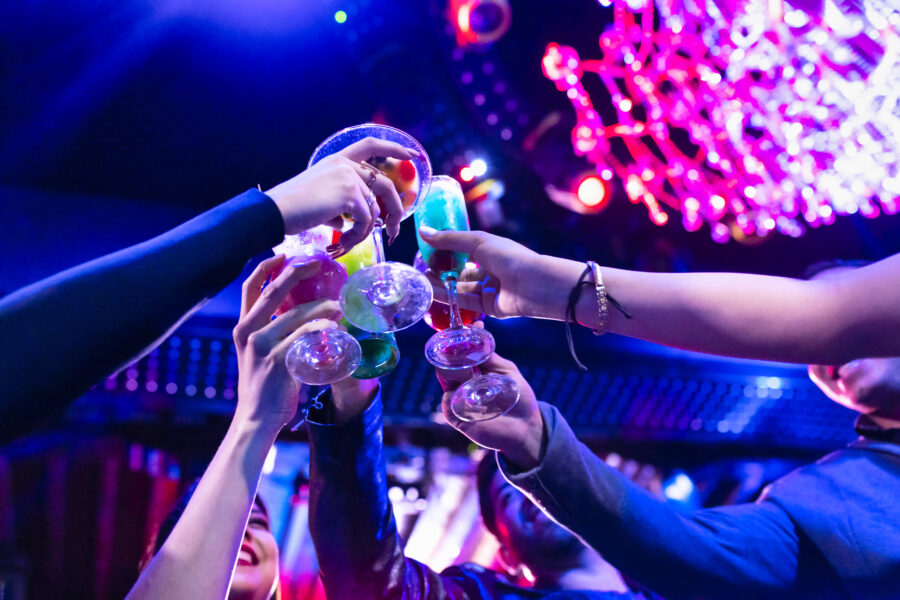 People clinking glasses in a nightclub