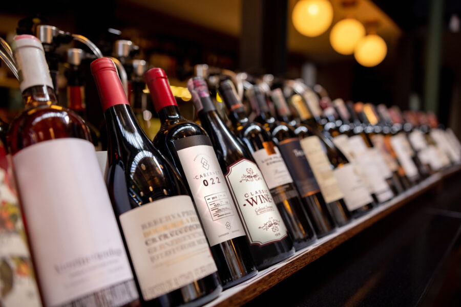 Close-up on bottles of wine displayed on the rack at a winery