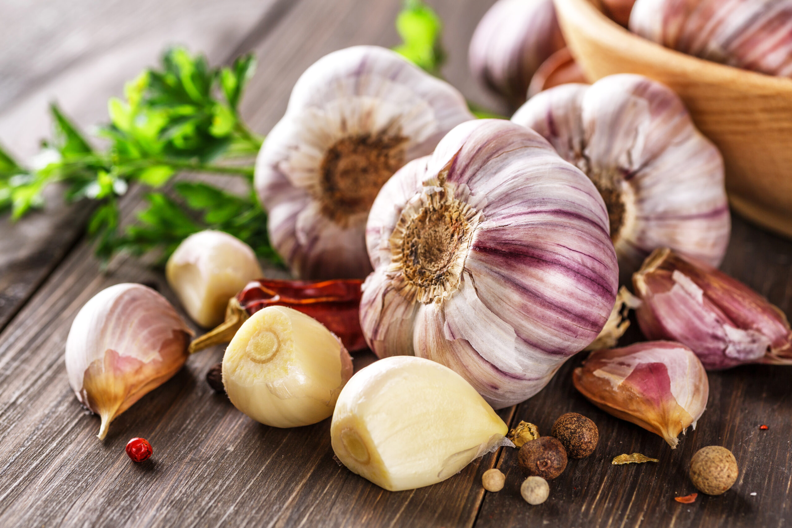 Closeup of Garlic bulbs on wooden table with garlics blur background.