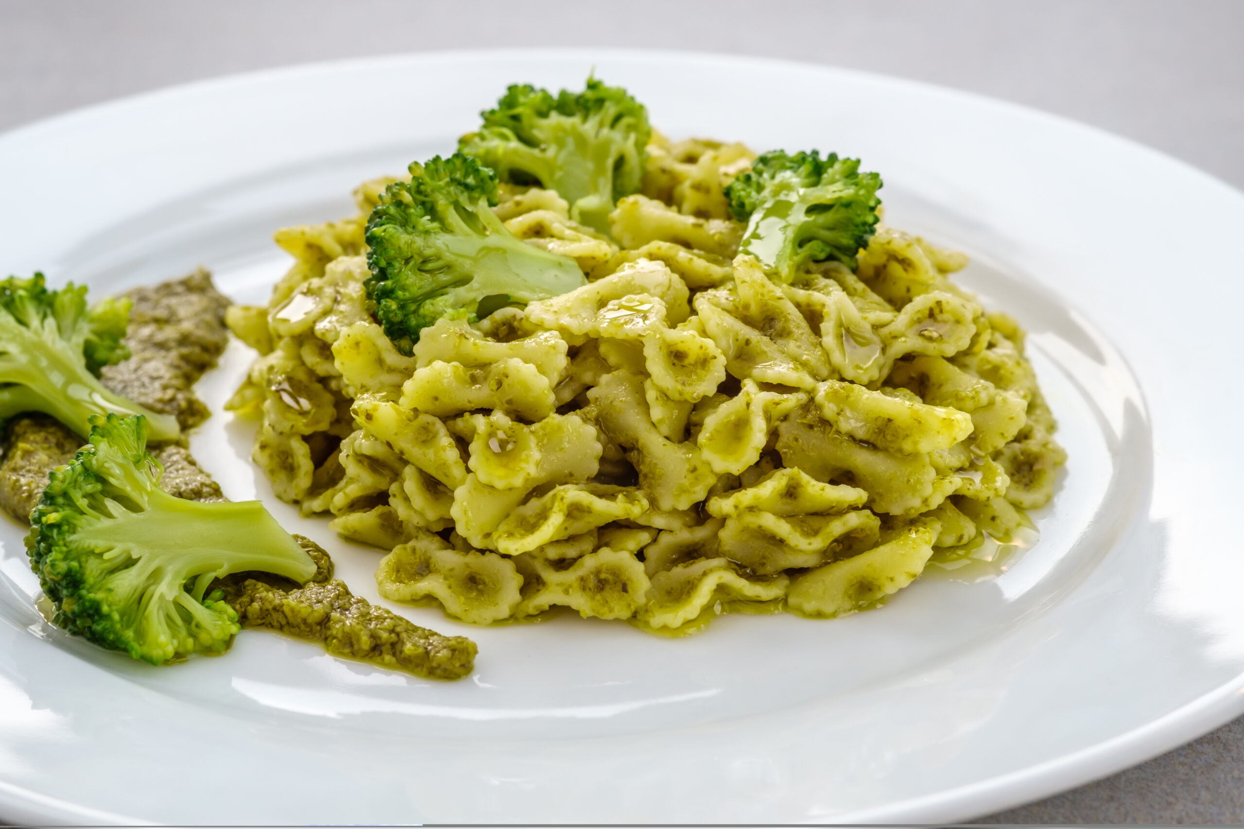 Farfalline pasta with pesto and broccoli on the plate