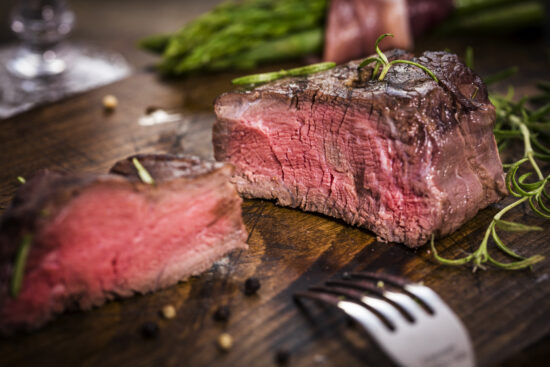 Grilled filet mignon with bacon and green asparagus