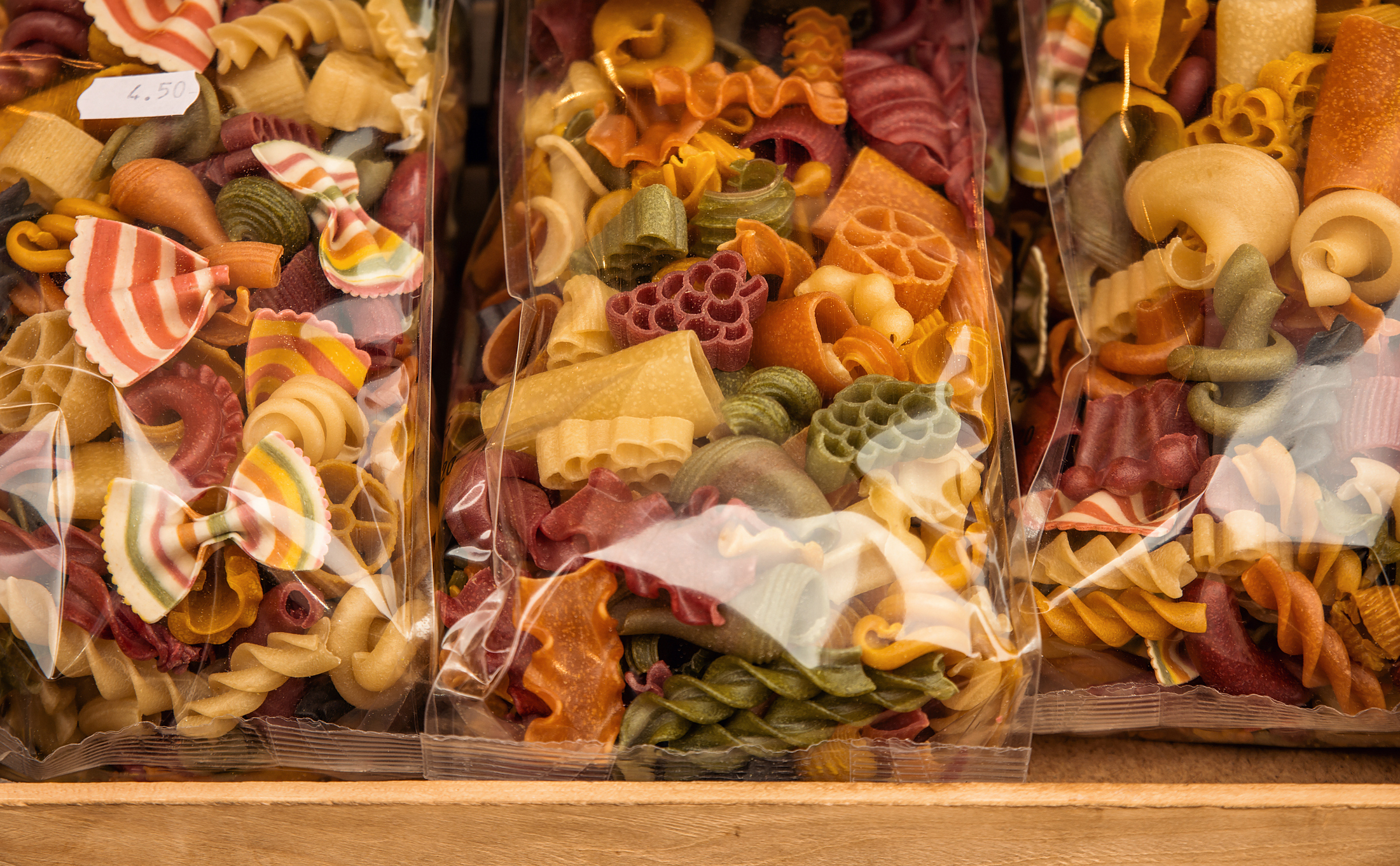 Colorful pasta made with vegetables in italian market stall