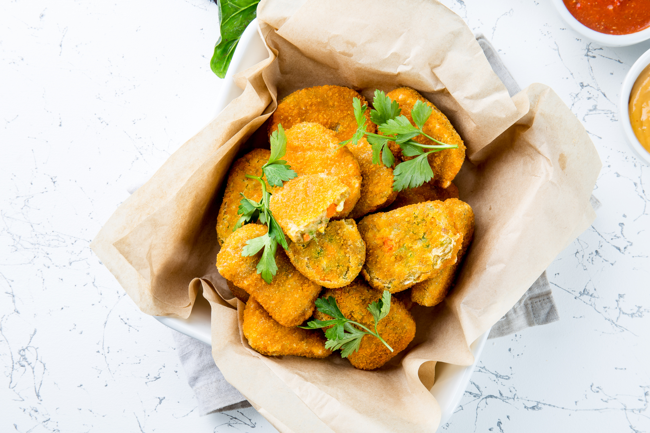 Healthy vegetarian nuggets with carrots, cauliflower and spinach. Vegetable nuggets. Vegan food. Top view, white background.