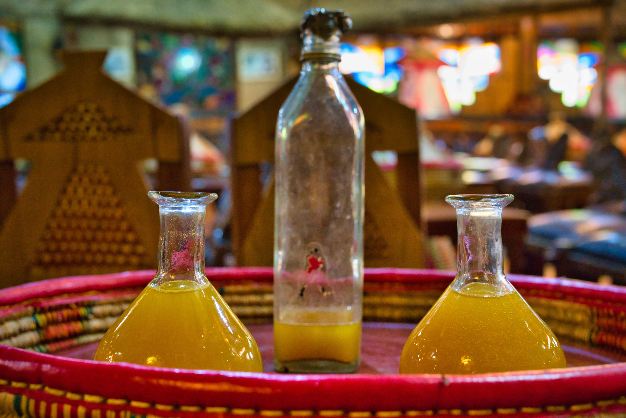 Addis Ababa, Ethiopia - December 18, 2018: Tej, a mead or honey wine that is brewed and consumed in Ethiopia, served on a platter in two drinking recipies.