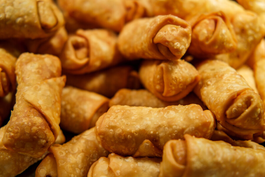 Crispy Chinese fried egg rolls in buffet tray at restaurant