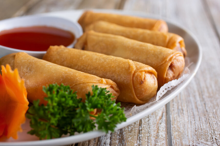 A view of a plate of egg rolls.