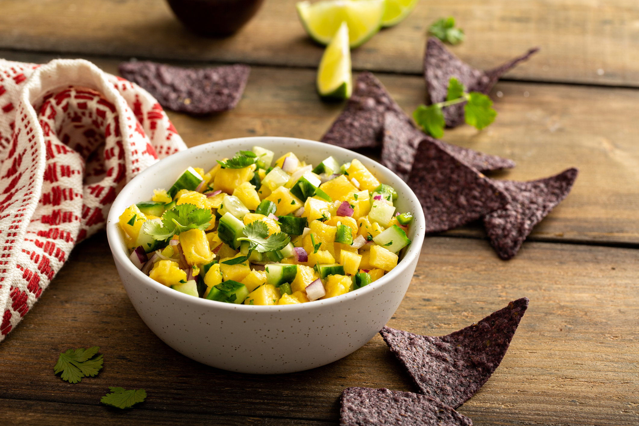 Pineapple and cucumber salsa with jalapeno and red onion served with chips