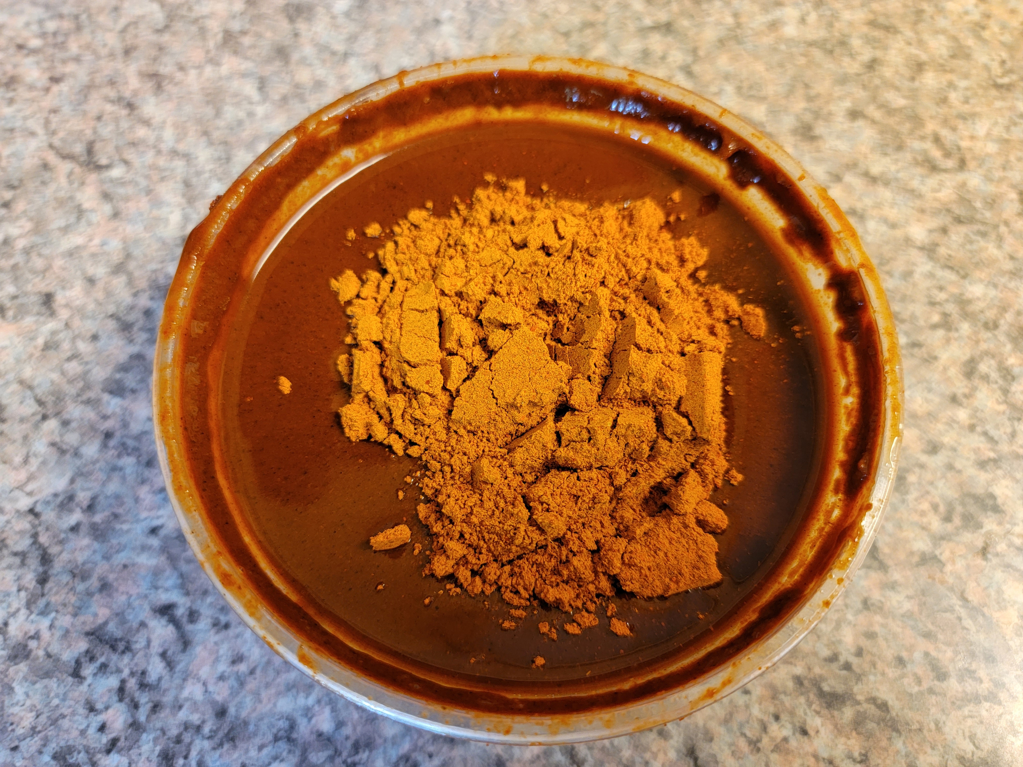 Ethiopian spices red awaze with berbere and mitmita hot peppers in container