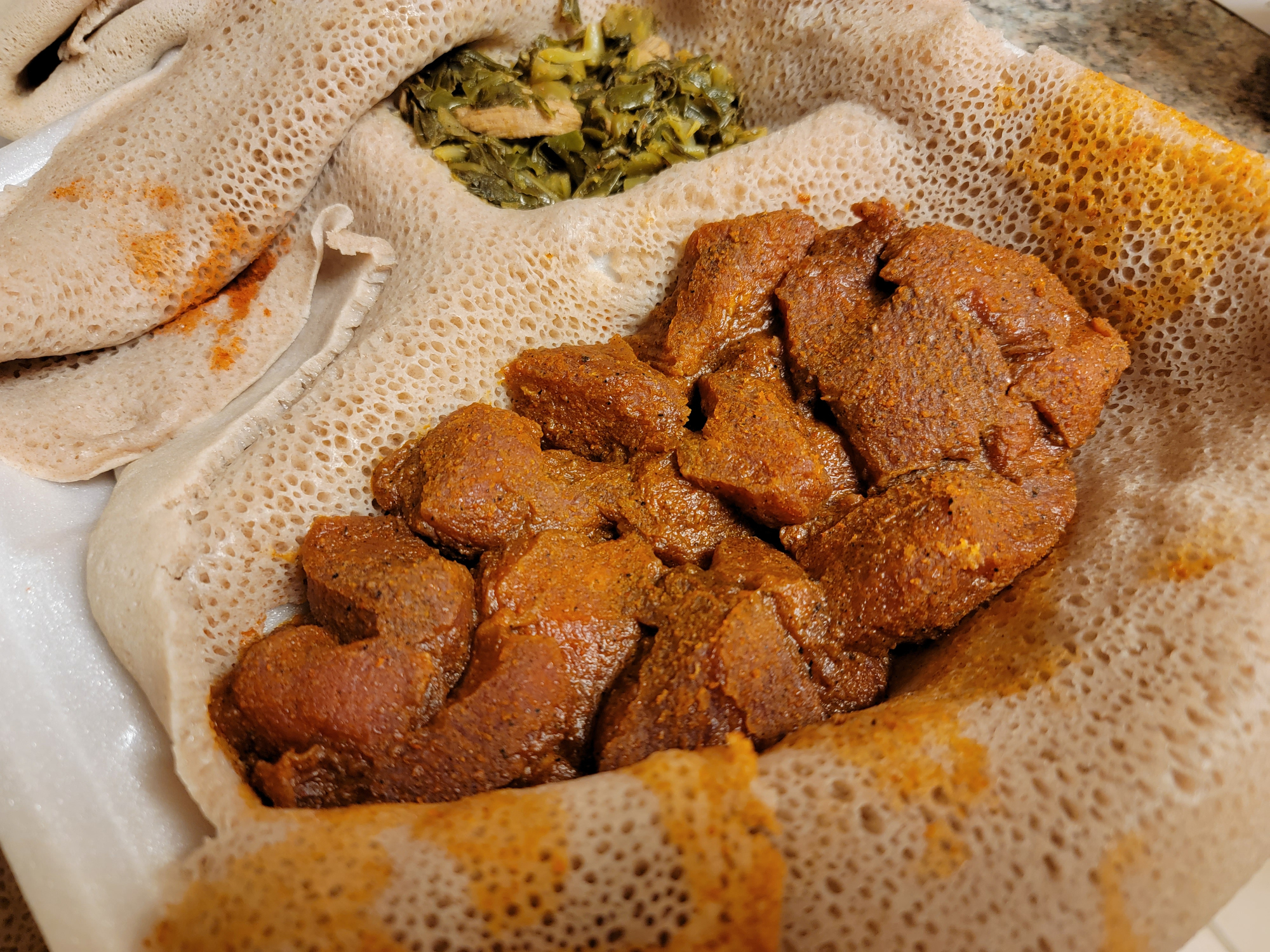 Ethiopian food delicious and spicy gored gored raw beef with injera bread