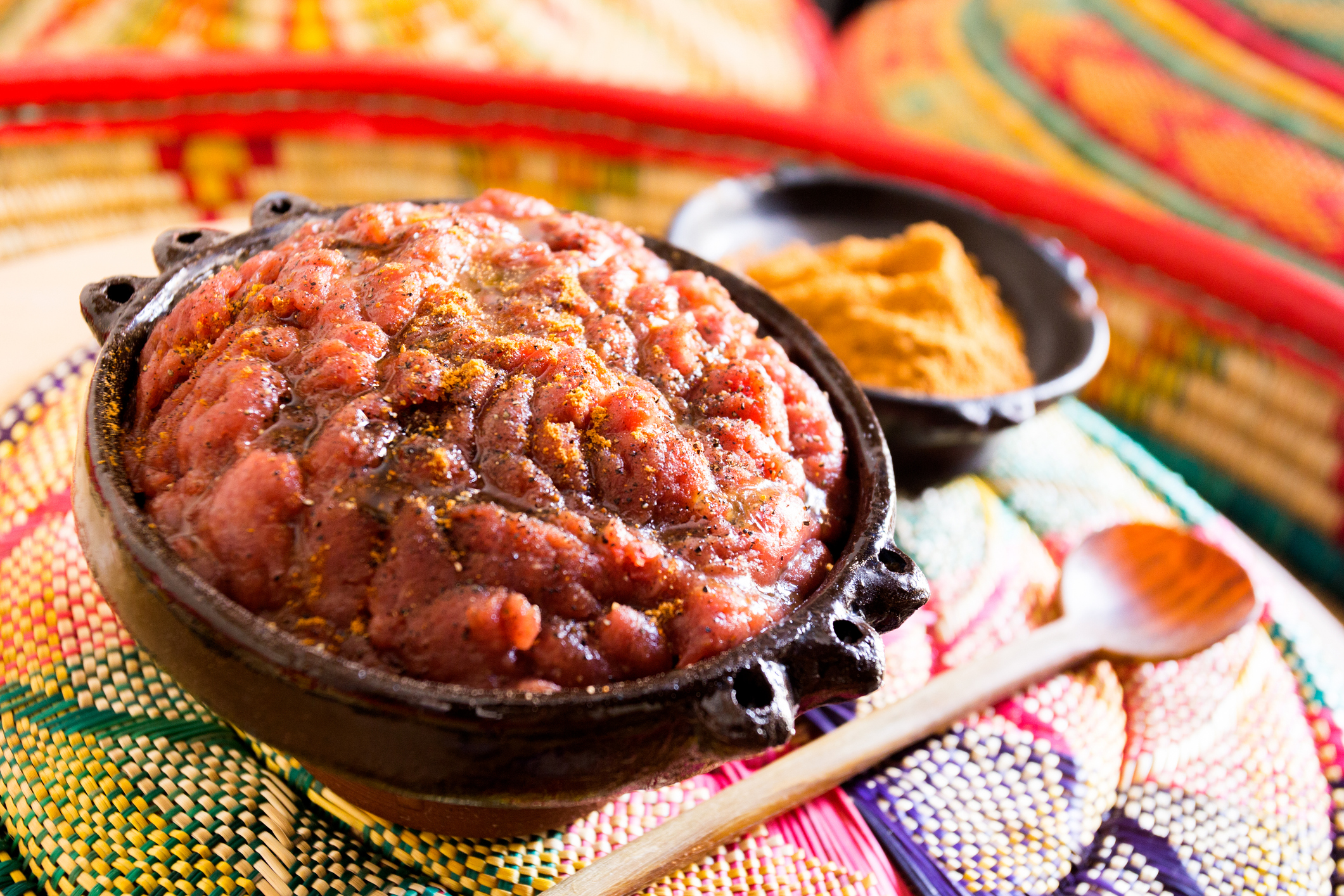 Ethiopian kifto. Kitfo is a traditional dish present in Ethiopian cuisine. It consists of raw minced beef, heated and marinated in mitmite.