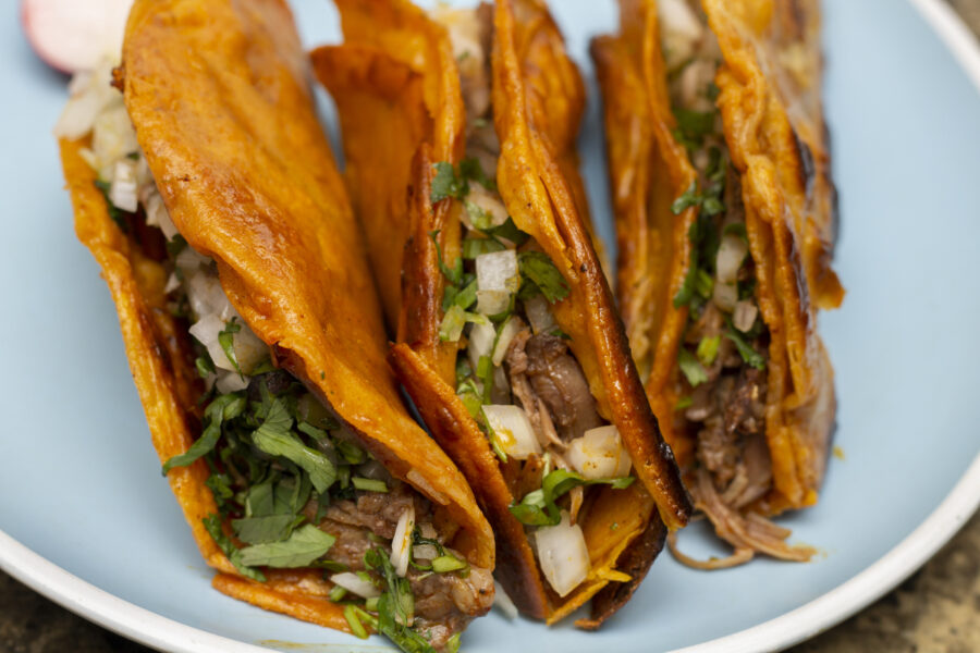 close up of 3 crispy birria tacos.