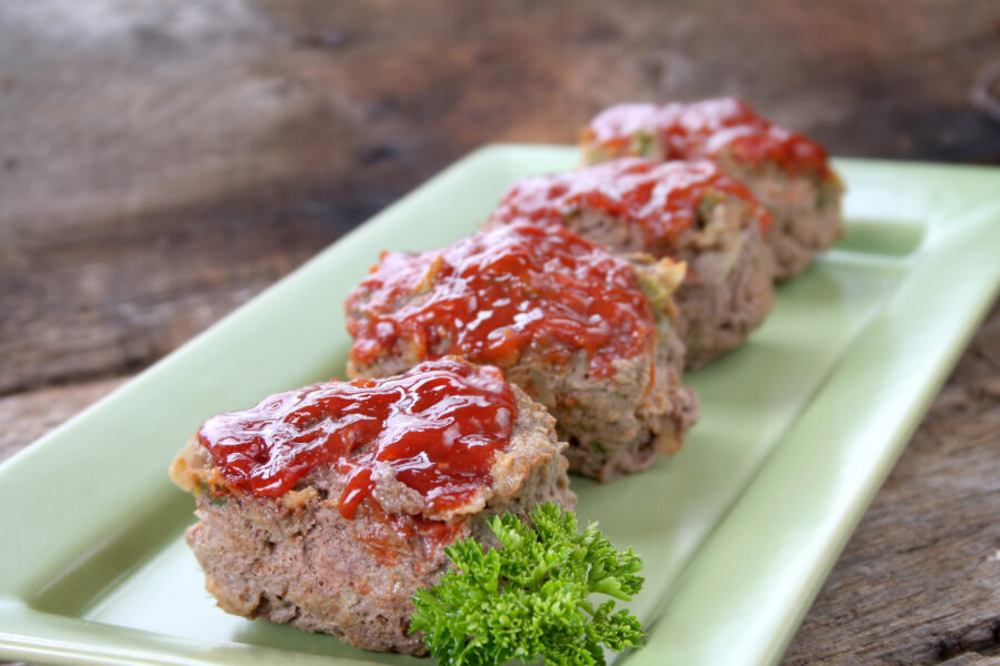 Mini Meat loafs on a tray with parsley.