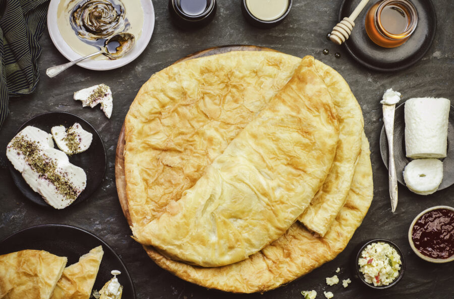 Feteer meshaltet is flaky layered pastry. It consists of many thin layers of dough and ghee. Served with black and white honey, tahini , cream, jam and cheese.