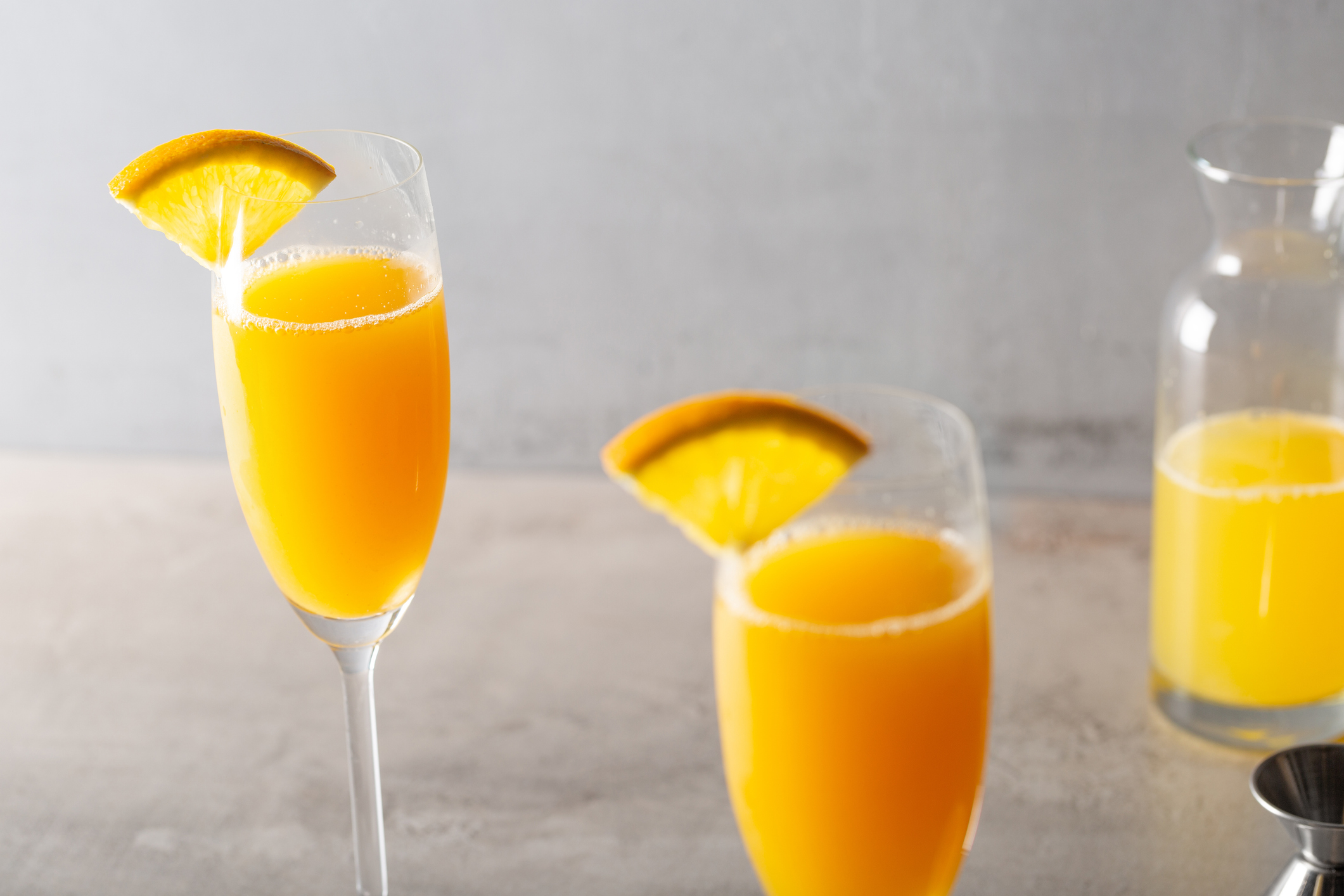 Homemade Mimosa Cocktail refreshment brut champagne or sparkling wine and fresh orange juice, garnish with orange slice