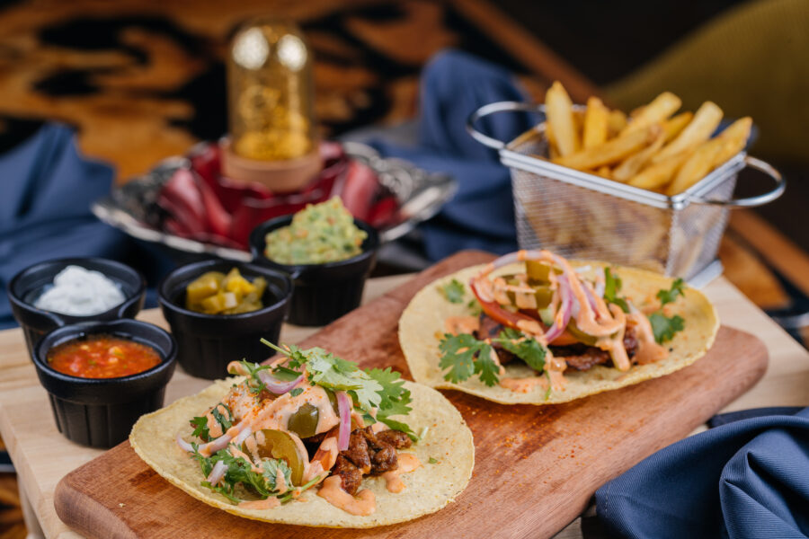 Mexican Tacos Al Carbon with french fries bucket served on wooden board isolated on table top view