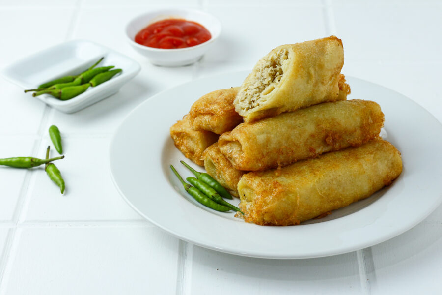 egg rolls stacked on a white plate