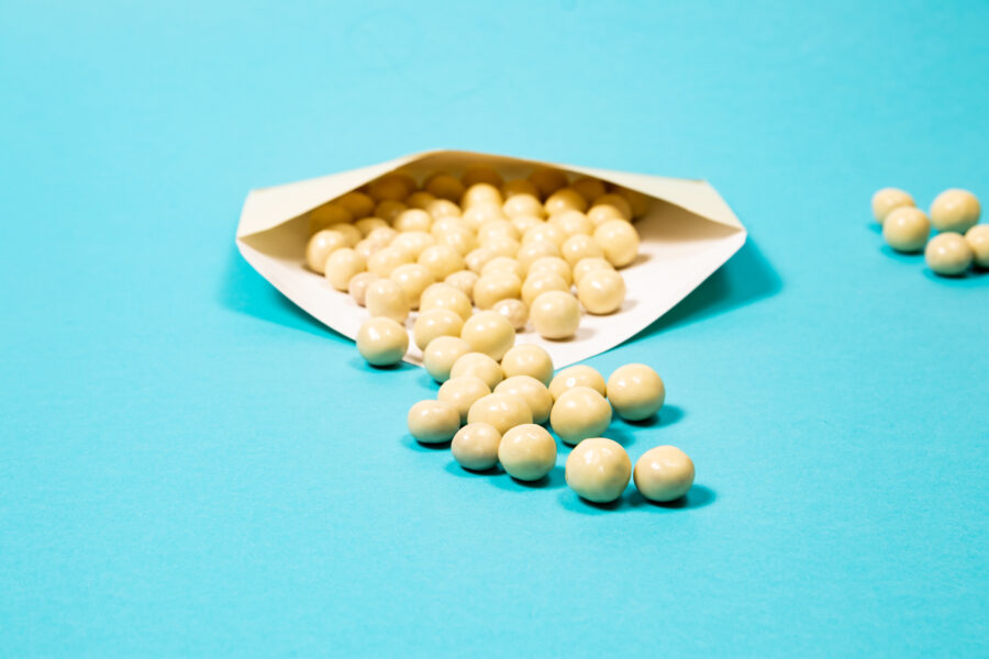 White chocolate balls on a blue background